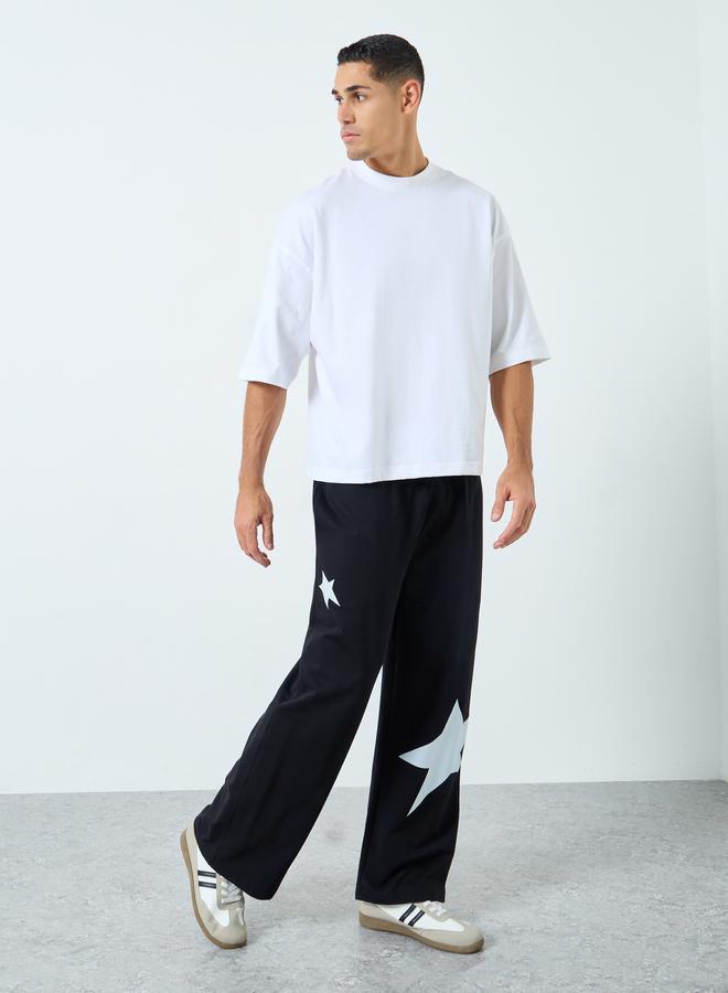 Styli Men Black Star Print Wide Leg Joggers - Image 1